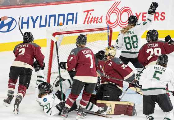 Boston’s Susanna Tapani (right) celebrates her game-winning goal against Montreal goaltender Ann-Renee Desbiens in overtime during PWHL playoff action in Montreal, Thursday. (THE CANADIAN PRESS/Christinne Muschi)