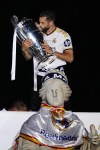 Real Madrid's Dani Carvajal kisses the Champions League trophy at the Cibeles square during a trophy parade in front of the City Hall in Madrid, Spain, Sunday, June 2, 2024. Real Madrid won against Borussia Dortmund 2-0. (AP Photo/Bernat Armangue)