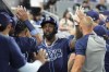 Tampa Bay Rays' Randy Arozarena is high-fived in the dugout after scoring on a double hit by Isaac Paredes during the first inning of a baseball game against the Miami Marlins, Wednesday, June 5, 2024, in Miami. (AP Photo/Lynne Sladky)