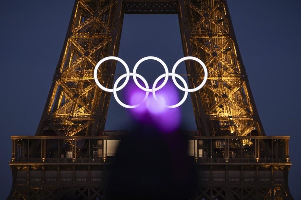 The Olympic rings are seen on the Eiffel Tower Friday, June 7, 2024, in Paris. The Paris Olympics organizers mounted the rings on the Eiffel Tower on Friday as the French capital marks 50 days until the start of the Summer Games. The 95-foot-long and 43-foot-high structure of five rings, made entirely of recycled French steel, will be displayed on the south side of the 135-year-old historic landmark in central Paris, overlooking the Seine River. (AP Photo/Aurelien Morissard)