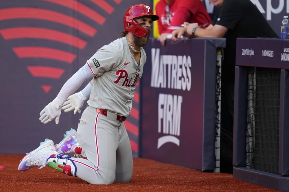 Philadelphia Phillies' Bryce Harper (3) celebrates after hitting a home run against the New York Mets during the fourth inning of a London Series baseball game in London, Saturday, June 8, 2024. (AP Photo/Kirsty Wigglesworth)