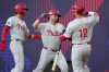 Philadelphia Phillies' Whit Merrifield, center, celebrates after hitting a 3-run home run against the New York Mets during the fourth inning of a London Series baseball game in London, Saturday, June 8, 2024. (AP Photo/Kirsty Wigglesworth)