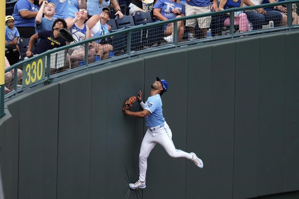 Kansas City Royals left fielder MJ Melendez chases after a solo home run ball hit by Seattle Mariners' Mitch Garver during the fifth inning of a baseball game Saturday, June 8, 2024, in Kansas City, Mo. (AP Photo/Charlie Riedel)