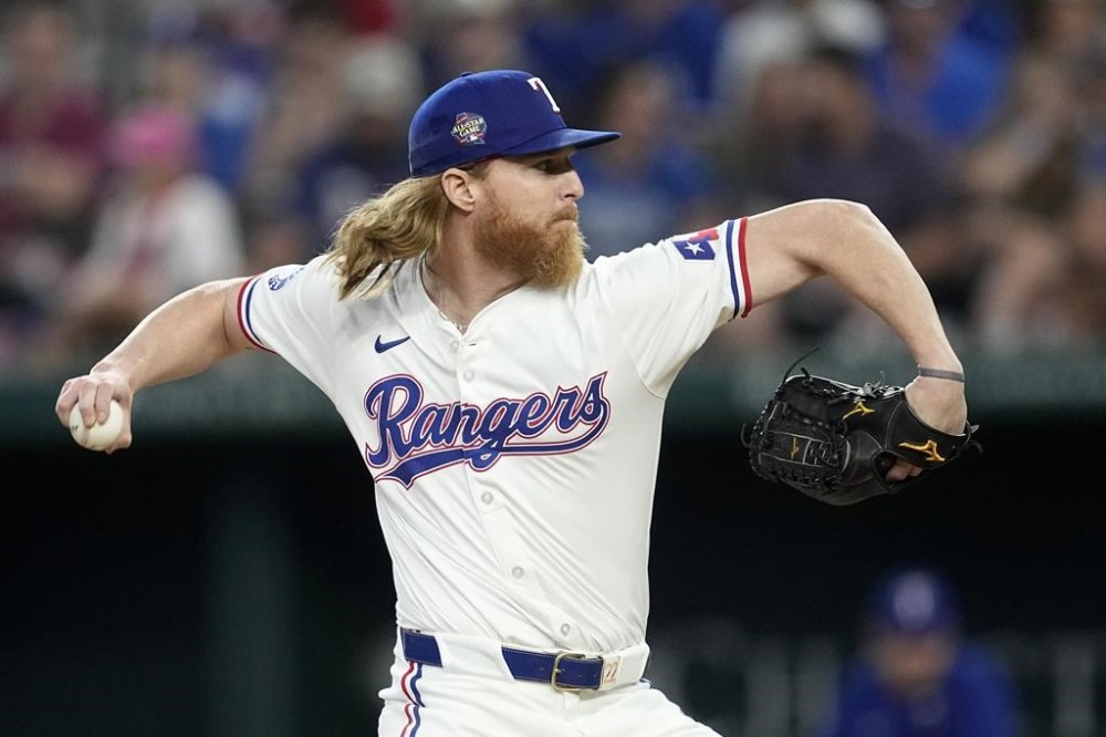 Texas Rangers relief pitcher Jon Gray throws to the San Francisco Giants in the sixth inning of a baseball game, Saturday, June 8, 2024, in Arlington, Texas. (AP Photo/Tony Gutierrez)