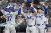 Los Angeles Dodgers' Teoscar Hernández (37) celebrates with teammates Will Smith (16), Mookie Betts (50) and Shohei Ohtani (17), of Japan, after hitting a grand slam during the eighth inning of a baseball game against the New York Yankees, Saturday, June 8, 2024, in New York. (AP Photo/Frank Franklin II)