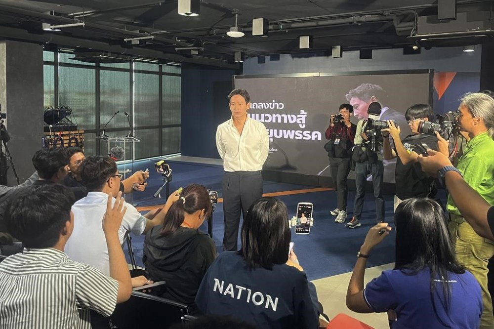 Former leader of Move Forward party Pita Limjaroenrat, center, talks to reporters during a news conference at the party's office in Bangkok, Thailand, Sunday, June 9, 2024. The former leader of Thailand’s progressive opposition Move Forward party vowed on Sunday to keep fighting as the party faces a court case that could result in its dissolution. (AP Photo/Jintamas Saksornchai)