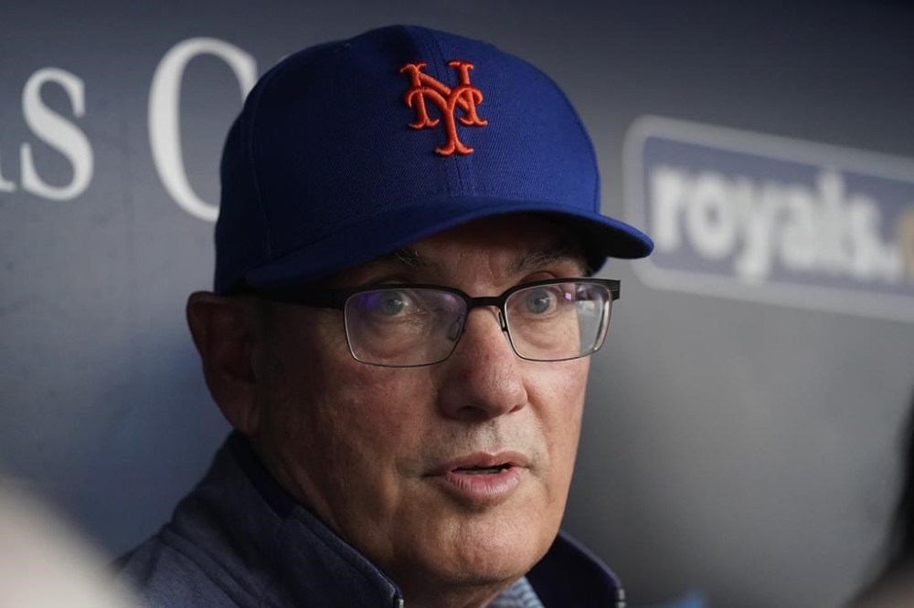 FILE - New York Mets owner Steve Cohen talks to the media in the dugout before a baseball game against the Kansas City Royals, Aug. 2, 2023, in Kansas City, Mo. Cohen says his team can still turn around its season and fans “have been through worse.