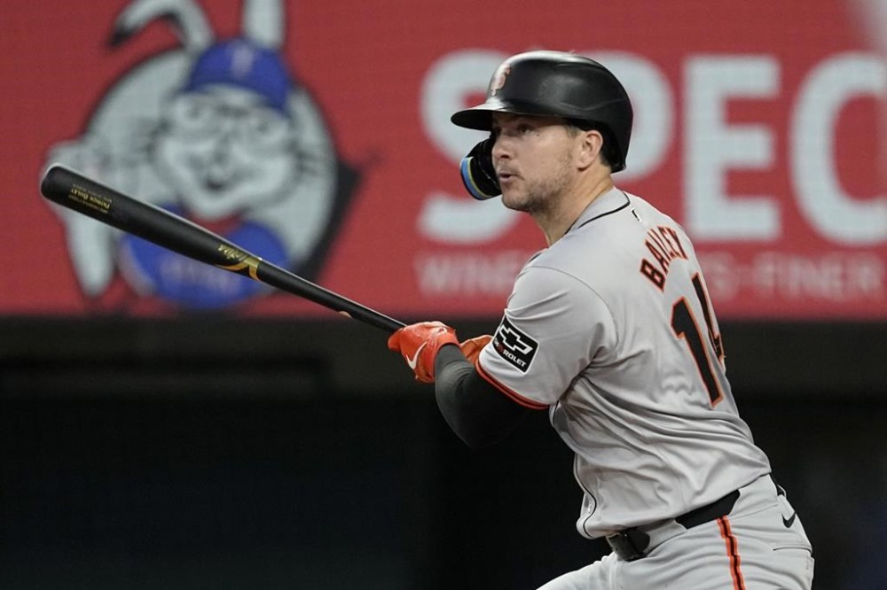 San Francisco Giants' Patrick Bailey follows through on a run-scoring single against the Texas Rangers in the third inning of a baseball game, Sunday, June 9, 2024, in Arlington, Texas. Casey Schmitt scored on the hit. (AP Photo/Tony Gutierrez)