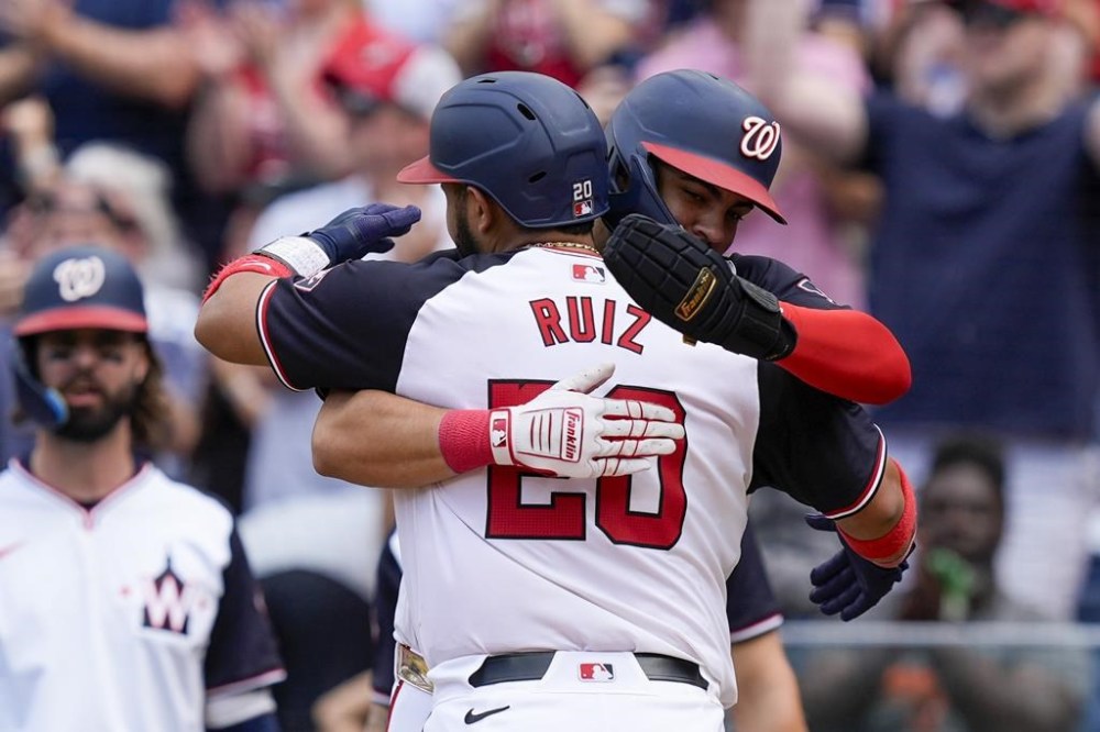 Washington Nationals' Keibert Ruiz and Luis García Jr. celebrate Ruiz's three-run homer during the fourth inning of a baseball game against the Atlanta Braves at Nationals Park, Sunday, June 9, 2024, in Washington. (AP Photo/Alex Brandon)