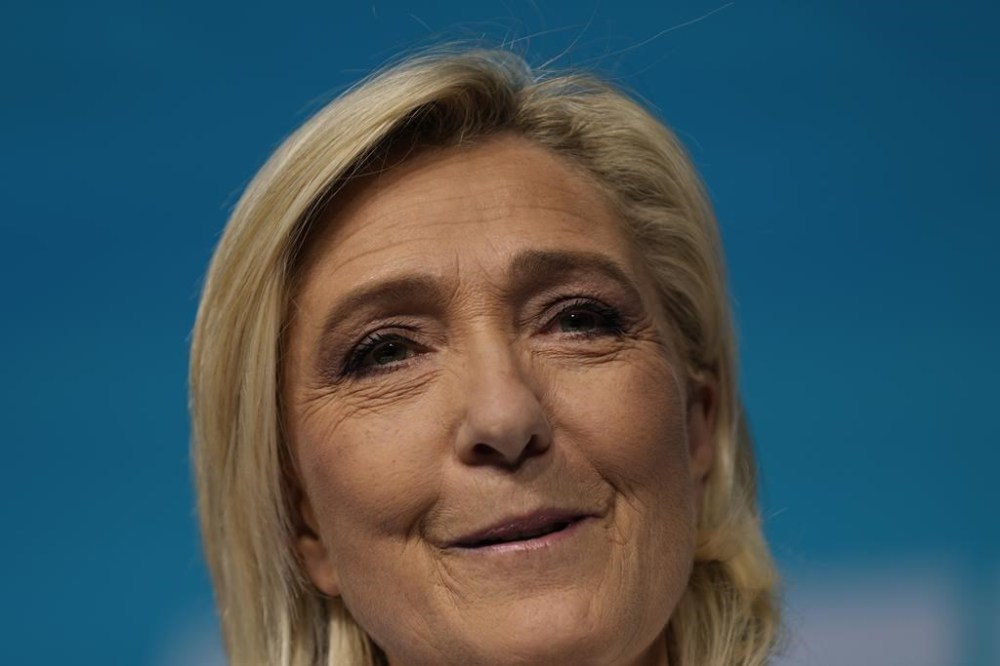 French far-right leader Marine Le Pen delivers he speech at the party election night headquarters after French President Emanuel Macron announced he dissolves National Assembly and calls new legislative election following the defeat in EU vote, Sunday, June 9, 2024 in Paris. First projected results from France put far-right National Rally party well ahead in EU elections, according to French opinion poll institutes. (AP Photo/Lewis Joly)