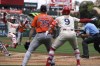Los Angeles Angels' Kevin Pillar, left, scores on a sacrifice fly by Nolan Schanuel as Houston Astros starting pitcher Justin Verlander, second from left, backs up the plate and shortstop Zach Neto, second from right, gestures during the second inning of a baseball game Sunday, June 9, 2024, in Anaheim, Calif. (AP Photo/Mark J. Terrill)