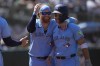 Toronto Blue Jays' Justin Turner, left, celebrates with Bo Bichette after both scored on a three run-double hit by Isiah Kiner-Falefa during the 10th inning of a baseball game against the Oakland Athletics in Oakland, Calif., Sunday, June 9, 2024. (AP Photo/Jeff Chiu)