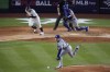 Los Angeles Dodgers pitcher Yoshinobu Yamamoto reaches for a ball hit by New York Yankees' Trent Grisham during the fifth inning of a baseball game, Friday, June 7, 2024, in New York. Grisham was out on the play. The Dodgers won 2-1 in 11 innings. (AP Photo/Frank Franklin II)