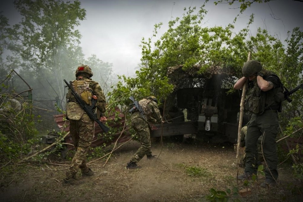In this photo taken on Friday, April 26, 2024 and released by the Russian Defense Ministry Press Service, Russian soldiers fire a 2A65