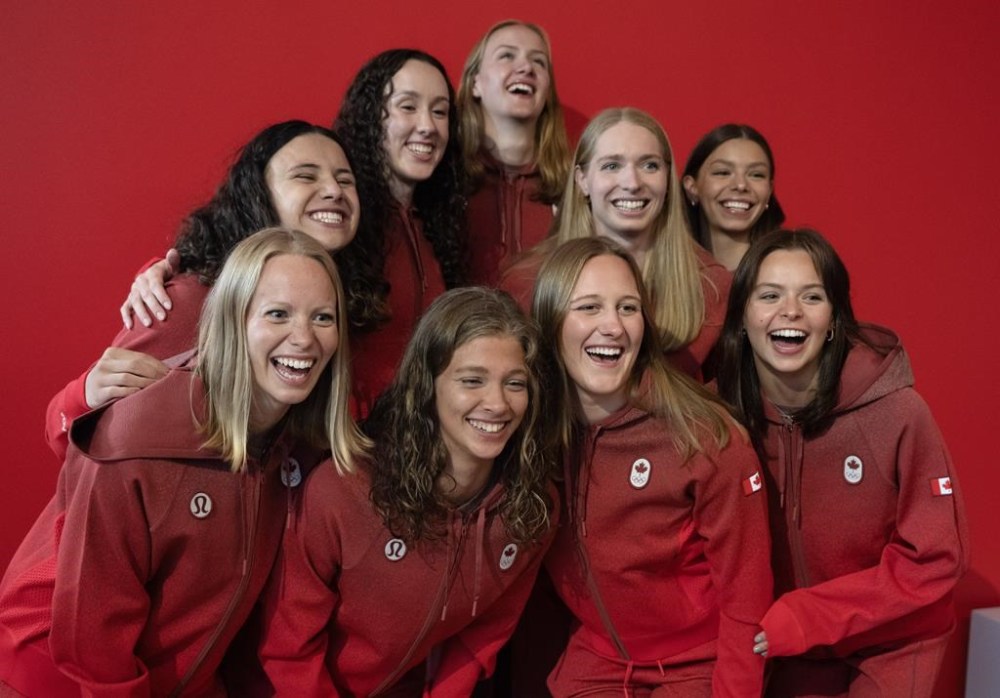 Members of Canada's 2024 Olympic artistic swim team, Scarlett Finn, Audrey Lamothe, Jonnie Newman, Raphaelle Plante, Kenzie Priddell, Claire Scheffel, Jacqueline Simoneau, Florence Tremblay, Sydney Carroll, pose for photos during a news conference in Montreal, Monday, June 10, 2024. THE CANADIAN PRESS/Ryan Remiorz