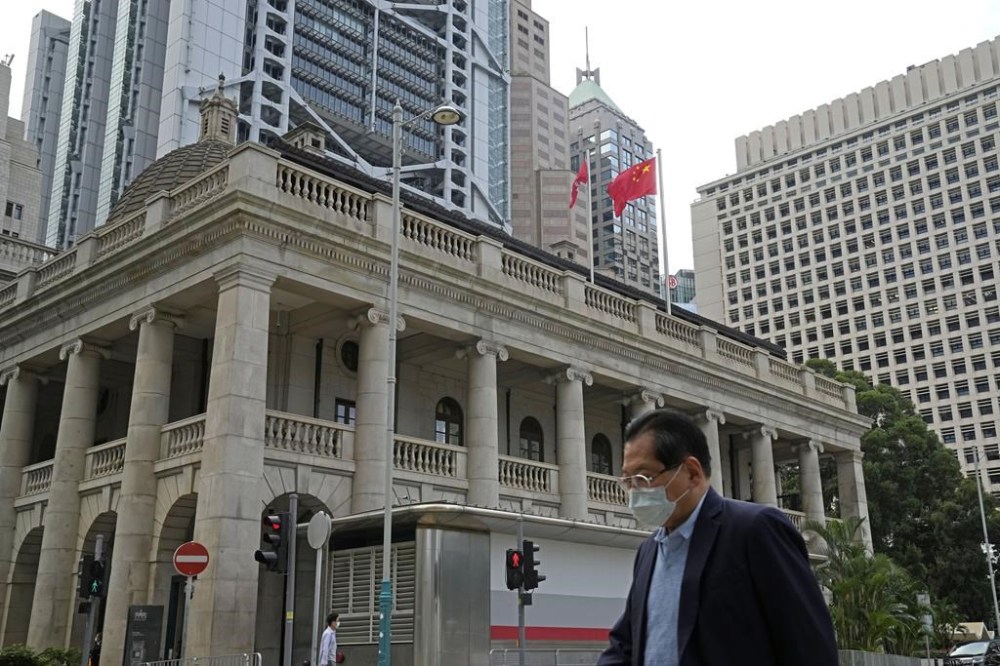 FILE - A pedestrian passes the Court of Final Appeal in Hong Kong, on March 30, 2022. A British judge who resigned from Hong Kong's top court last week said he stepped down because the rule of law in the city is in