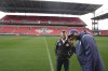 Canadian international defender Doneil Henry is adding coaching duties to his role as sporting director of League1 Ontario's Simcoe County Rovers. Simcoe County Rovers President, CEO and co-owner Peter Raco, left, and Henry take a phone call as they inspect the pitch of the team's training session at BMO field, in Toronto, Tuesday, April 23, 2024. THE CANADIAN PRESS/Chris Young