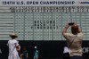 Fans gather around the main scoreboard during a practice round for the U.S. Open golf tournament Monday, June 10, 2024, in Pinehurst, N.C. (AP Photo/Matt York)
