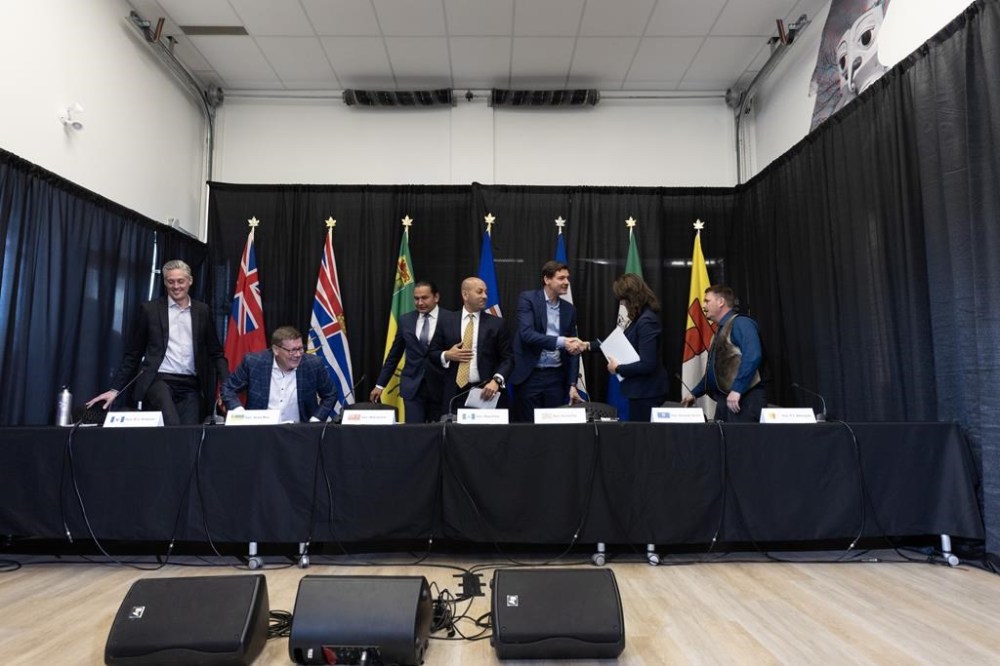Northwest Territories Premier R.J Simpson, from left, Saskatchewan Premier Scott Moe, Manitoba Premier Wab Kinew, Yukon Premier Ranj Pillai, British Columbia Premier David Eby, Alberta Premier Danielle Smith and Nunavut Premier P.J. Akeeagok chat at the conclusion of a media availability at the 2024 Western Premiers’ Conference in Whitehorse, Monday, June 10, 2024. CANADIAN PRESS/Crystal Schick
