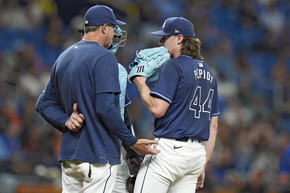 Tampa Bay Rays pitching coach Kyle Snyder talks to starting pitcher Ryan Pepiot (44) during the fifth inning of a baseball game against the Baltimore Orioles Monday, June 10, 2024, in St. Petersburg, Fla. (AP Photo/Chris O'Meara)