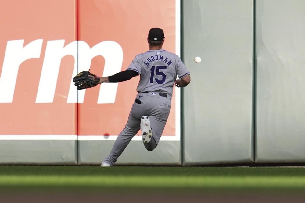 Colorado Rockies right fielder Hunter Goodman fields a double hit by Minnesota Twins' Manuel Margot during the third inning of a baseball game Monday, June 10, 2024, in Minneapolis. (AP Photo/Abbie Parr)