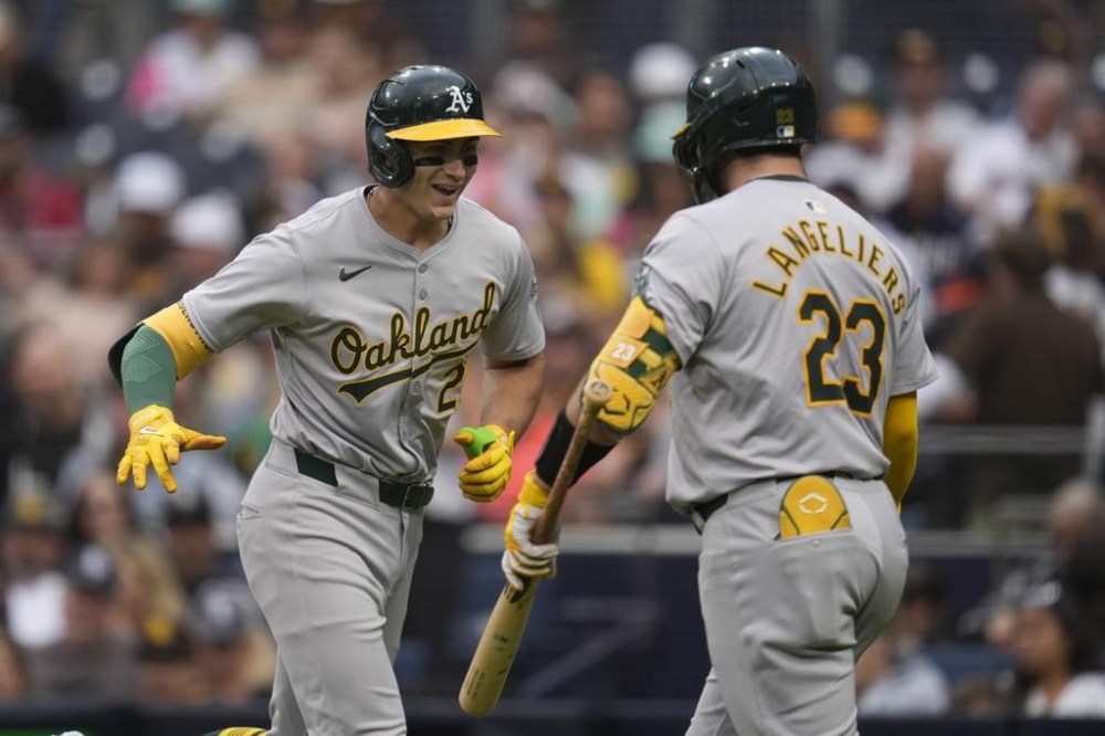 Oakland Athletics' Tyler Soderstrom, left, celebrates with teammate Shea Langeliers after hitting a home run during the second inning of a baseball game against the San Diego Padres, Monday, June 10, 2024, in San Diego. (AP Photo/Gregory Bull)
