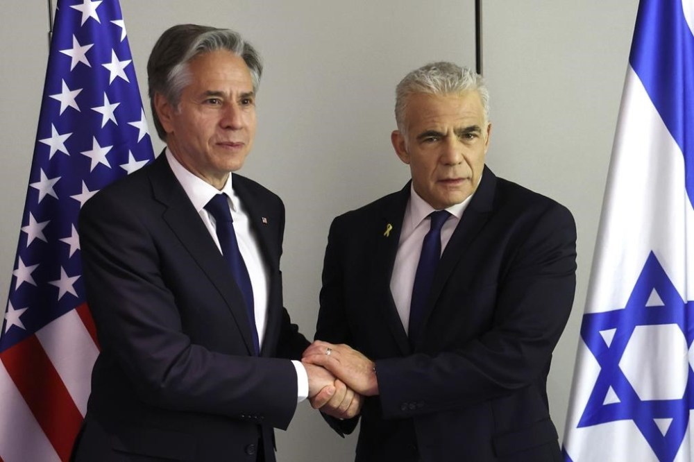 U.S. Secretary of State Antony Blinken, left, shakes hands with Israeli opposition leader Yair Lapid during a meeting in Tel Aviv Tuesday, June 11, 2024. (Jack Guez/Pool Photo via AP)