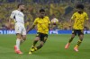 Real Madrid's Dani Carvajal challenges for the ball with Dortmund's Ian Maatsen during the Champions League final soccer match between Borussia Dortmund and Real Madrid at Wembley stadium in London, Saturday, June 1, 2024. (AP Photo/Kirsty Wigglesworth)