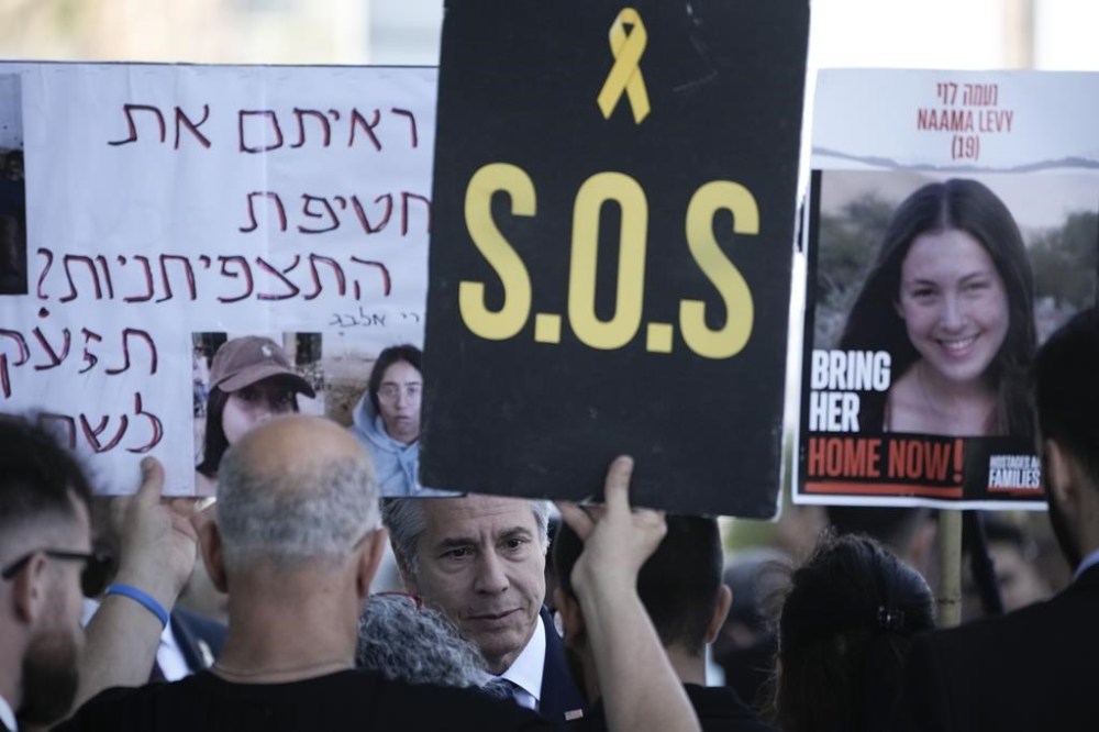 U.S. Secretary of State Antony Blinken meets families and supporters of Israeli hostages held by Hamas in Gaza as they hold banners and flags during a protest calling for their return, in Tel Aviv, Israel, Tuesday, June 11, 2024. (AP Photo/Leo Correa)