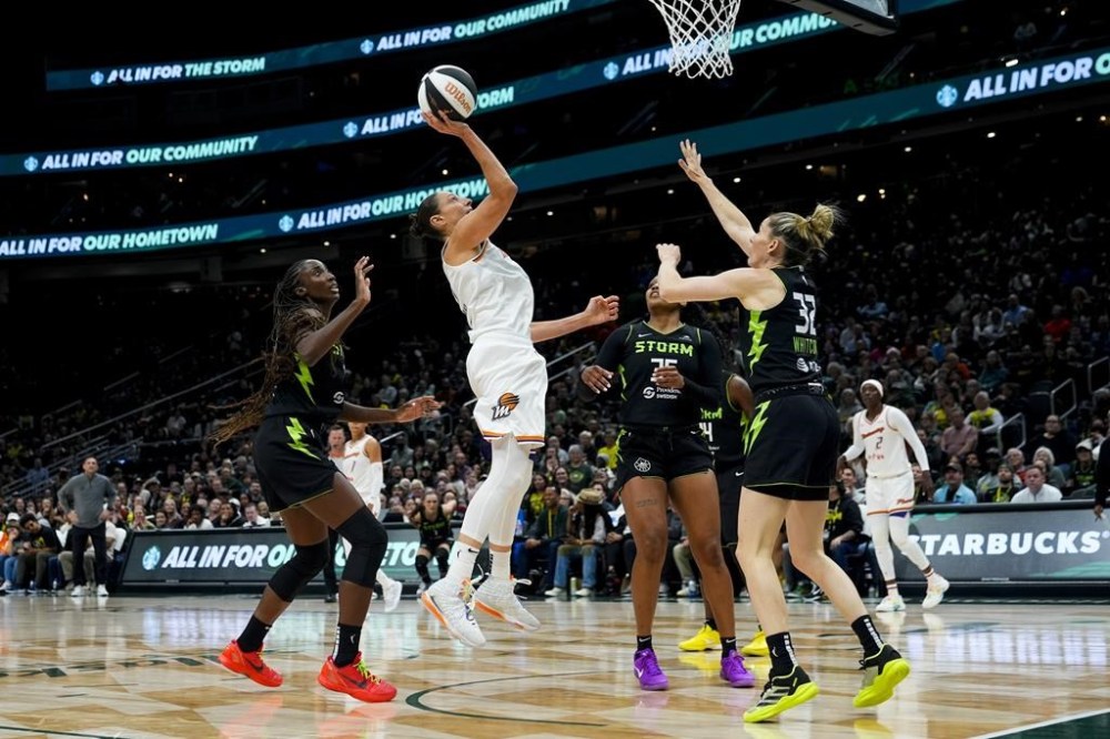 Phoenix Mercury guard Diana Taurasi goes up for a basket but doesn't make it against the defense from Seattle Storm center Ezi Magbegor, left, guard Victoria Vivians and guard Sami Whitcomb (32) during the second half of a WNBA basketball game, Tuesday, June 4, 2024, in Seattle. The Storm won 80-62. (AP Photo/Lindsey Wasson)