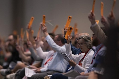 Messengers raise their ballots in support of a resolution put up for vote during a Southern Baptist Convention annual meeting Tuesday, June 11, 2024, in Indianapolis. (AP Photo/Doug McSchooler)