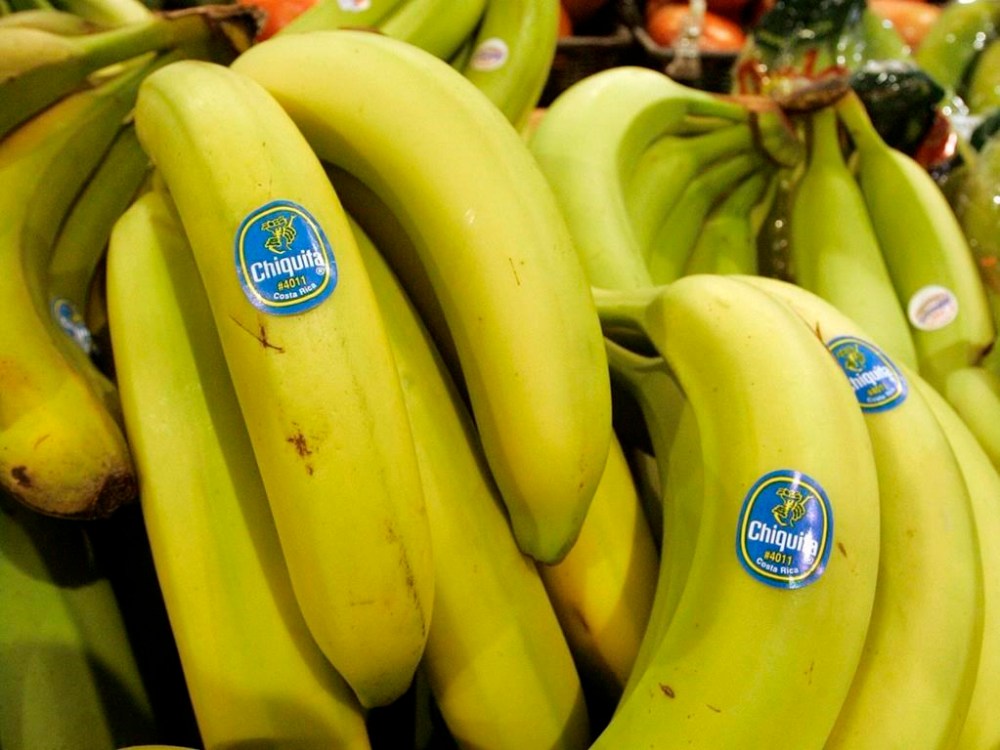 FILE - Chiquita bananas are piled on display at the Heinen's grocery store in Bainbridge, Ohio in this Aug. 3, 2005 file photo. A federal jury in Florida found that Chiquita Brands must pay $38.3 million to 16 family members of people killed during Colombia’s long civil war by a violent right-wing paramilitary group funded by the company. The verdict Monday, June 10, 2024 by a jury in West Palm Beach marks the first time the company has been found liable in any of multiple similar lawsuits pending elsewhere in U.S. courts, lawyers for the plaintiffs said. (AP Photo/Amy Sancetta, file)