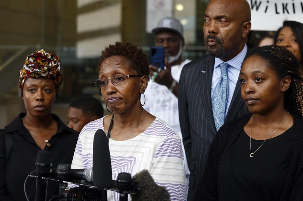 Jacqualyne Johnson, mother of Anthony Johnson Jr., center, is framed by daughters Janell and Chanel while speaking during a press conference outside of the Tim Curry Criminal Justice Center, Tuesday, June 11, 2024, in Fort Worth, Texas. Last week the medical examiner in Tarrant County ruled that Anthony Johnson Jr.'s death was a homicide, citing asphyxia from use of force and pepper spray as the cause of death. Johnson died earlier this year after being restrained in a jail. (Amanda McCoy/Star-Telegram via AP)