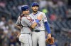 New York Mets relief pitcher Danny Young, right, and catcher Luis Torrens, left, celebrate after a baseball game against the Washington Nationals, Wednesday, June 5, 2024, in Washington. The Mets won 9-1. (AP Photo/Nick Wass)