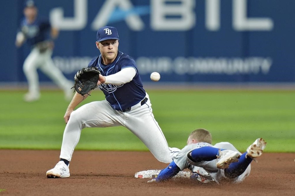 Chicago Cubs' Pete Crow-Armstrong, right, slides in to second base ahead of the throw to Tampa Bay Rays shortstop Taylor Walls after advancing on an error by Yandy Diaz during the fifth inning of a baseball game Tuesday, June 11, 2024, in St. Petersburg, Fla. (AP Photo/Chris O'Meara)