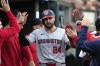 Washington Nationals' Joey Gallo is greeted in the dug out after scoring during the fifth inning of a baseball game against the Detroit Tigers, Tuesday, June 11, 2024, in Detroit. (AP Photo/Carlos Osorio)