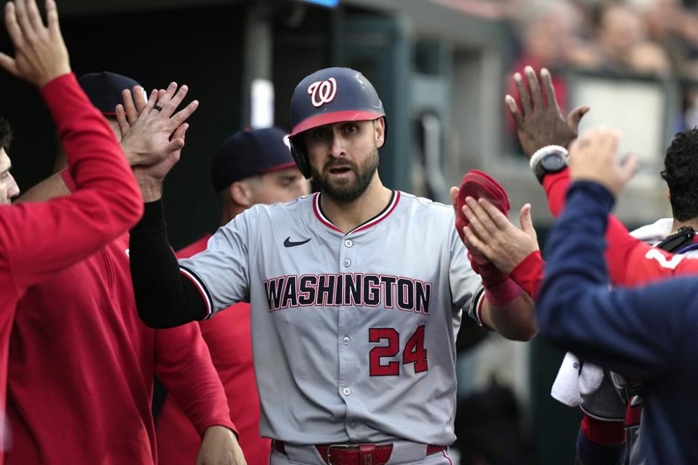 Washington Nationals' Joey Gallo is greeted in the dug out after scoring during the fifth inning of a baseball game against the Detroit Tigers, Tuesday, June 11, 2024, in Detroit. (AP Photo/Carlos Osorio)