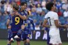 Japan midfielder Koki Saito, back, celebrates with Shota Fujio (9) after Fujio scored a goal on a penalty kick during the first half of an international friendly soccer match against the United States Tuesday, June 11, 2024, in Kansas City, Kan. (AP Photo/Charlie Riedel)