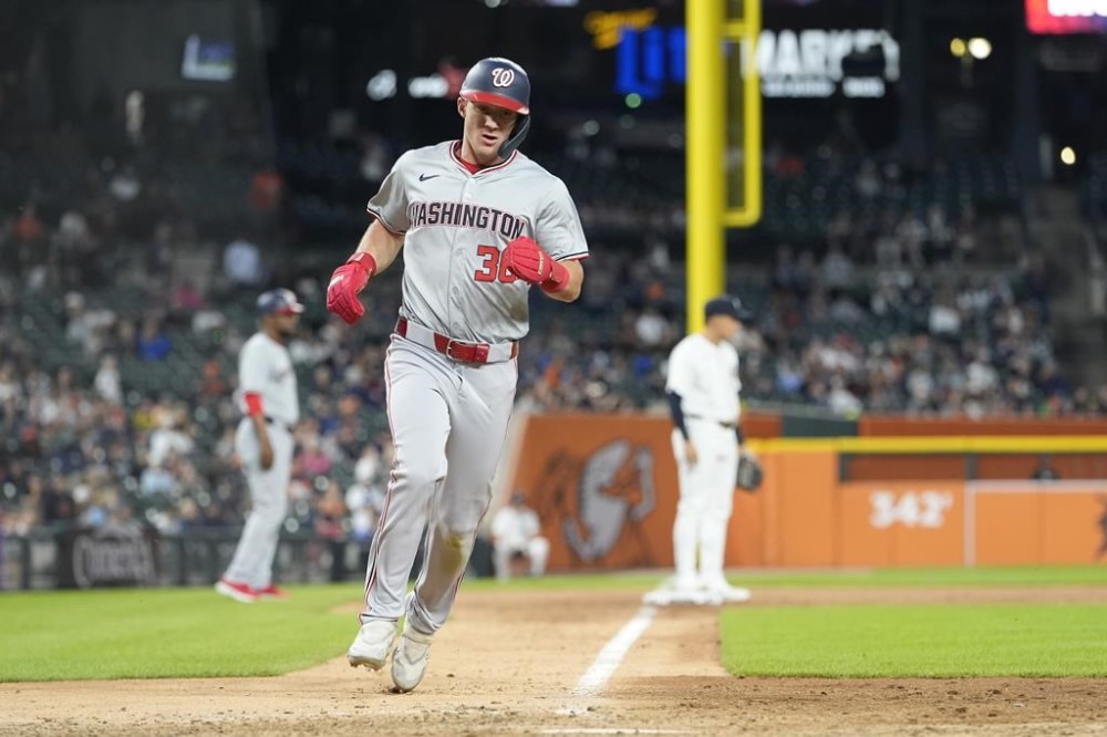 Washington Nationals' Jacob Young scores from third on a sacrifice by teammate Lane Thomas during the 10th inning of a baseball game against the Detroit Tigers, Tuesday, June 11, 2024, in Detroit. (AP Photo/Carlos Osorio)