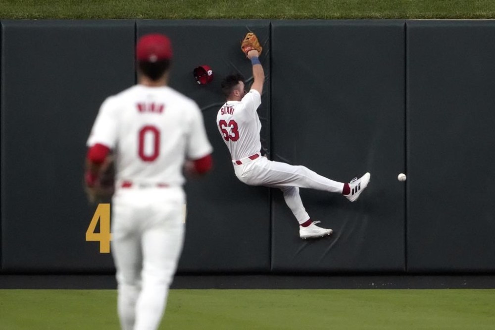 St. Louis Cardinals center fielder Michael Siani (63) is unable to catch a triple by Pittsburgh Pirates' Bryan Reynolds as Cardinals shortstop Masyn Winn (0) watches during the seventh inning of a baseball game Tuesday, June 11, 2024, in St. Louis. (AP Photo/Jeff Roberson)