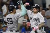 New York Yankees' Alex Verdugo, right, celebrates with New York Yankees' Aaron Judge (99) after Judge hit a two-run home run against the Kansas City Royals during the seventh inning of a baseball game, Tuesday, June 11, 2024, in Kansas City, Mo. (AP Photo/Reed Hoffmann)