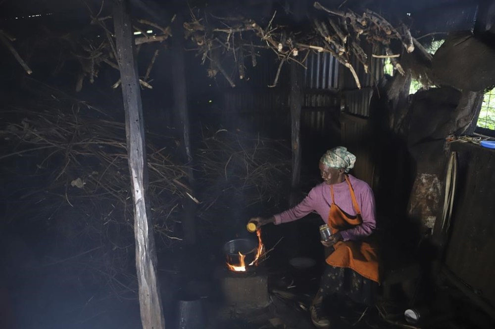 Jane Muthoni, 65, cooks using firewood at her home in Kiambu, Kenya, Tuesday, May 21, 2024. Respiratory diseases have been the most prevalent diseases in Kenya for the past several years and are on the rise, according to government authorities, with 19.6 million reported cases last year. Burning biomass such as firewood is the largest contributor to those diseases. (AP Photo/Andrew Kasuku)