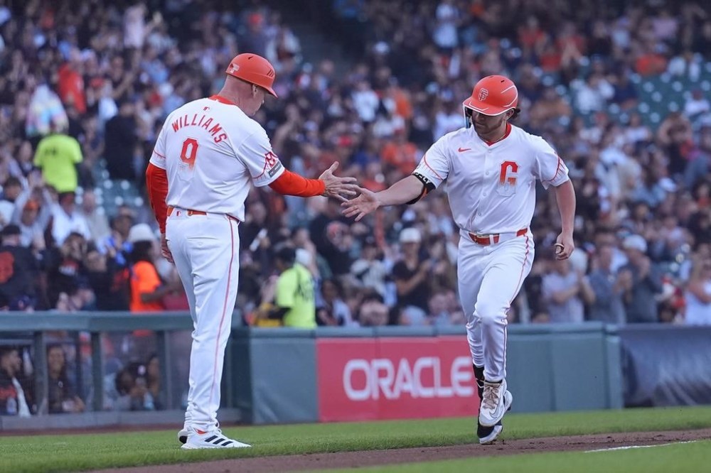 San Francisco Giants' Brett Wisely, right, is congratulated by third base coach Matt Williams after hitting a home run against the Houston Astros during the third inning of a baseball game in San Francisco, Tuesday, June 11, 2024. (AP Photo/Jeff Chiu)