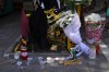 FILE - Candles and flowers are placed at the location where a 29-year-old Greek soccer fan died after overnight clashes between rival supporters in Nea Philadelphia suburb, in Athens, Greece, Aug. 8, 2023. A recent surge in violence around soccer games is contributing to alarm over security when Germany hosts the European Championship. Some 22,000 police officers will be on duty each day for the tournament. (AP Photo/Thanassis Stavrakis, File)