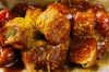 Currywurst, Germany's sausage with curry sauce, served on a cardboard at Konnopke's Imbiß, a fast-food joint under the tracks at the Eberswalder Straße U-Bahn station in Berlin, Germany, Thursday, June 6, 2024. The currywurst promises to be among the most tantalizing gourmet treats on offer at the European Championship this summer. The currywurst is considered a fast-food delicacy in a country where the humble sausage enjoys great importance. (AP Photo/Markus Schreiber)