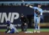 Toronto Blue Jays second baseman Cavan Biggio (8) forces out Kansas City Royals' Maikel Garcia (11) at second base but doesn't turn the double play over in time during ninth inning American League MLB baseball action in Toronto on April 29, 2024. THE CANADIAN PRESS/Nathan Denette