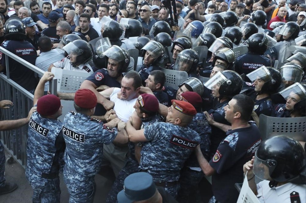 Police block the way to protesters during a rally against Prime Minister Nikol Pashinyan in Yerevan, Armenia, Wednesday, June 12, 2024. (Hayk Baghdasaryan/Photolure via AP)