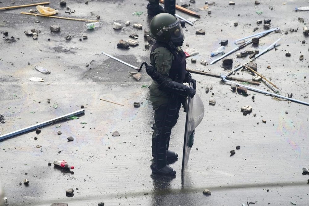 Riot police stand by during anti-government protests outside Congress, as lawmakers debate a reform bill promoted by Argentine President Javier Milei in Buenos Aires, Argentina, Wednesday, June 12, 2024. (AP Photo/Natacha Pisarenko)
