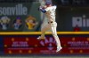 Milwaukee Brewers' Brice Turang makes a late throw on a ball hit by Toronto Blue Jays' Spencer Horwitz in the third inning of a baseball game Wednesday, June 12, 2024, in Milwaukee. (AP Photo/Jeffrey Phelps)