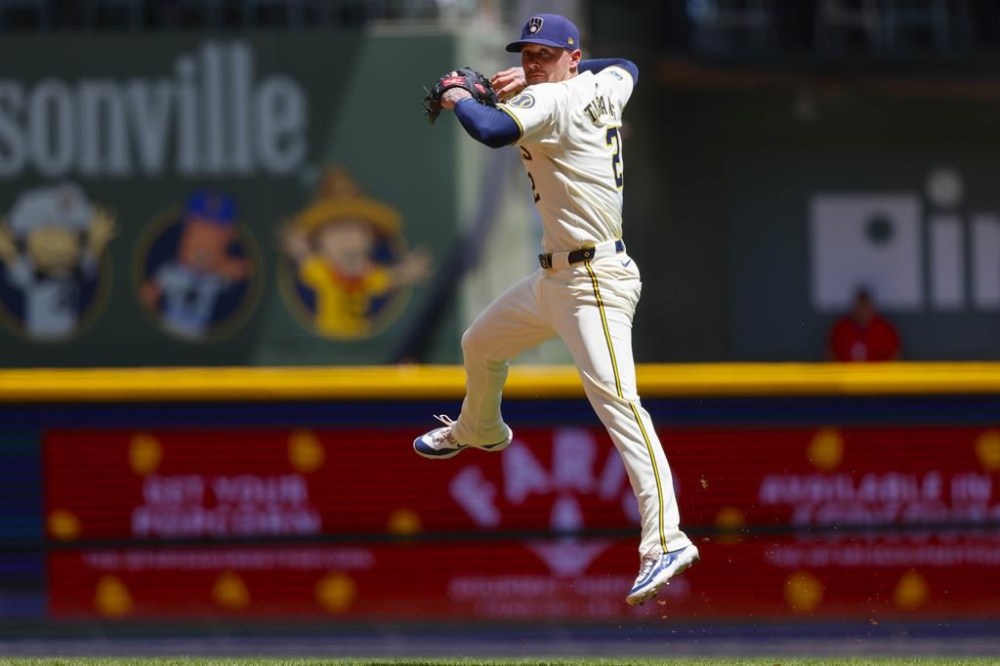 Milwaukee Brewers' Brice Turang makes a late throw on a ball hit by Toronto Blue Jays' Spencer Horwitz in the third inning of a baseball game Wednesday, June 12, 2024, in Milwaukee. (AP Photo/Jeffrey Phelps)